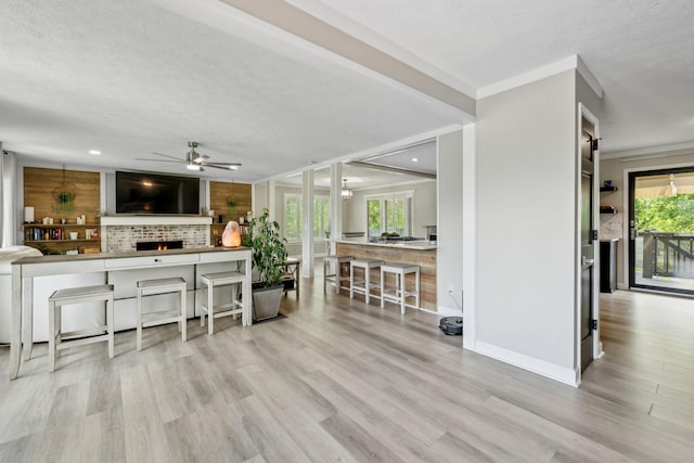 living area with wood finished floors, baseboards, ceiling fan, recessed lighting, and a textured ceiling