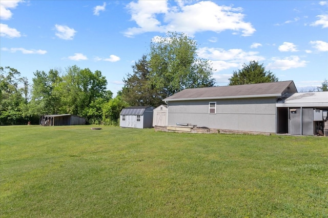 view of yard featuring an outbuilding and a storage shed