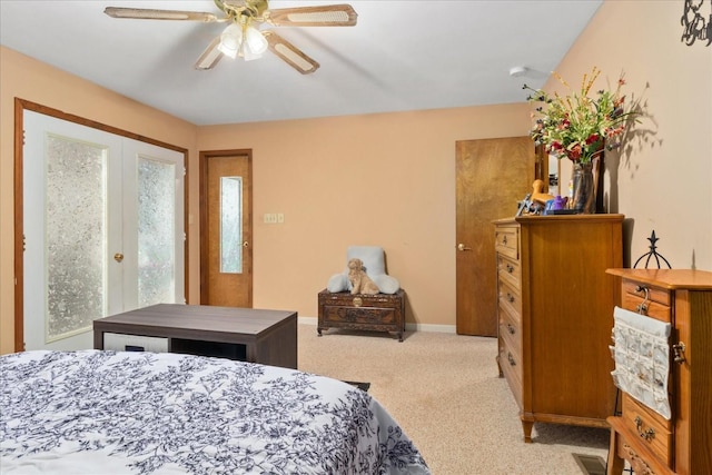 bedroom featuring baseboards, a ceiling fan, and light colored carpet