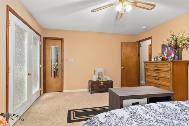 carpeted bedroom featuring baseboards and a ceiling fan