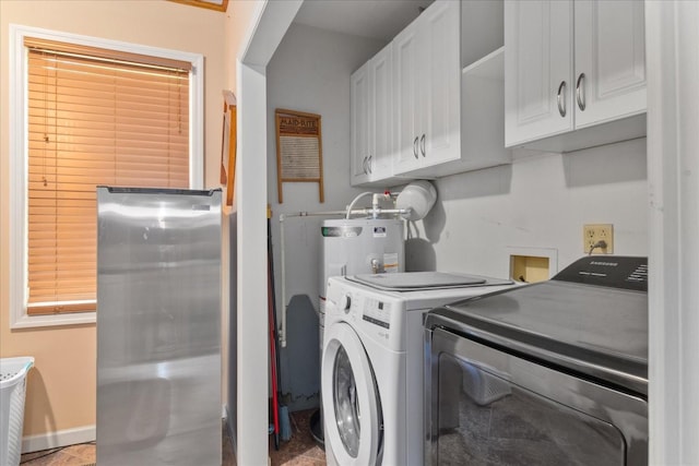 washroom featuring baseboards, cabinet space, and washing machine and clothes dryer