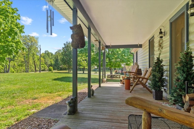 deck featuring a yard and a porch