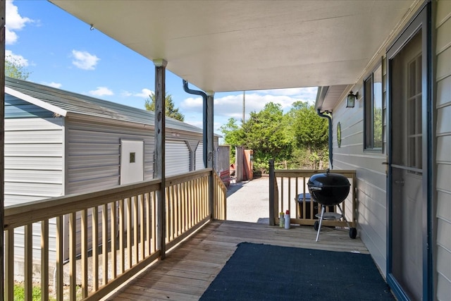 wooden terrace with a grill
