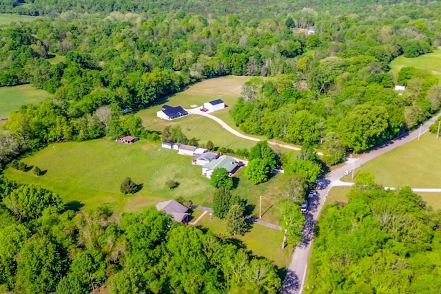 drone / aerial view featuring a wooded view
