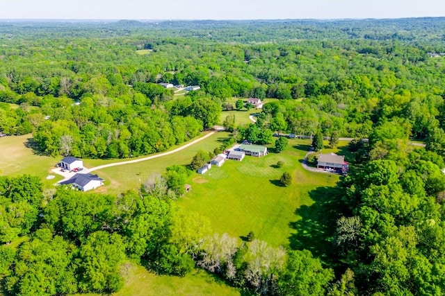 birds eye view of property with a wooded view