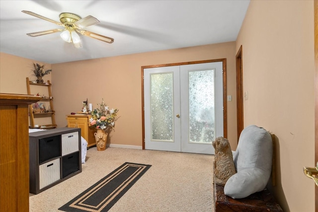 interior space featuring french doors, carpet flooring, baseboards, and ceiling fan