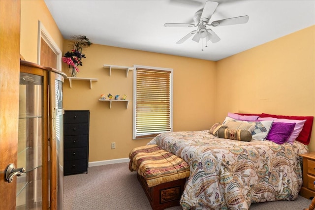 carpeted bedroom with baseboards and a ceiling fan