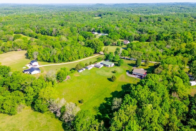 birds eye view of property featuring a wooded view