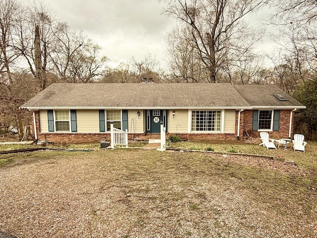 single story home featuring brick siding