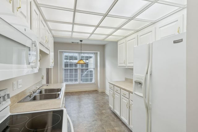 8508 Sawyer Brown Rd, Nashville, TN 37221 - kitchen with hanging light fixtures, light countertops, a sink, white cabinets, and white appliances