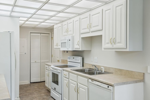 8508 Sawyer Brown Rd, Nashville, TN 37221 - kitchen with a sink, white cabinetry, white appliances, and light countertops