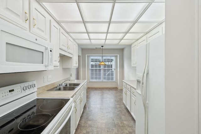 8508 Sawyer Brown Rd, Nashville, TN 37221 - kitchen with decorative light fixtures, a sink, light countertops, white cabinets, and white appliances