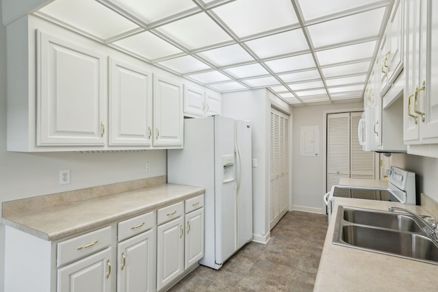 8508 Sawyer Brown Rd, Nashville, TN 37221 - kitchen with electric range, a sink, baseboards, white cabinets, and white fridge with ice dispenser