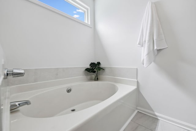 bathroom with baseboards and a garden tub