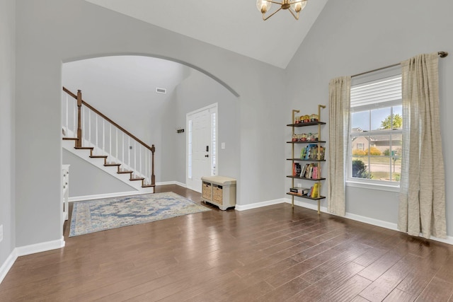 2095 Longhunter Chase Dr, Spring Hill, TN 37174 - foyer with arched walkways, baseboards, high vaulted ceiling, and wood finished floors