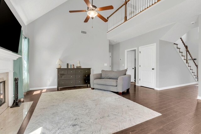 2095 Longhunter Chase Dr, Spring Hill, TN 37174 - living room with visible vents, stairs, wood finished floors, ceiling fan, and high vaulted ceiling