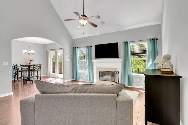 2095 Longhunter Chase Dr, Spring Hill, TN 37174 - living area with arched walkways, plenty of natural light, ceiling fan with notable chandelier, and wood finished floors