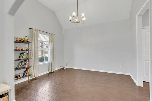 2095 Longhunter Chase Dr, Spring Hill, TN 37174 - unfurnished dining area featuring baseboards, dark wood-type flooring, arched walkways, a notable chandelier, and vaulted ceiling
