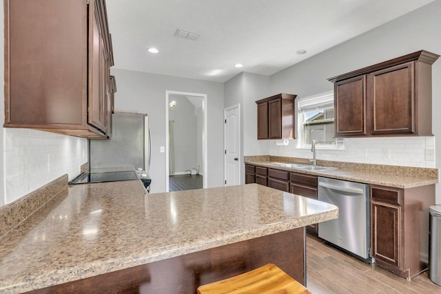2095 Longhunter Chase Dr, Spring Hill, TN 37174 - kitchen featuring a sink, decorative backsplash, a peninsula, and dishwasher