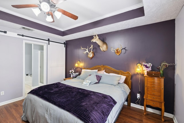 bedroom with visible vents, baseboards, crown molding, and wood finished floors
