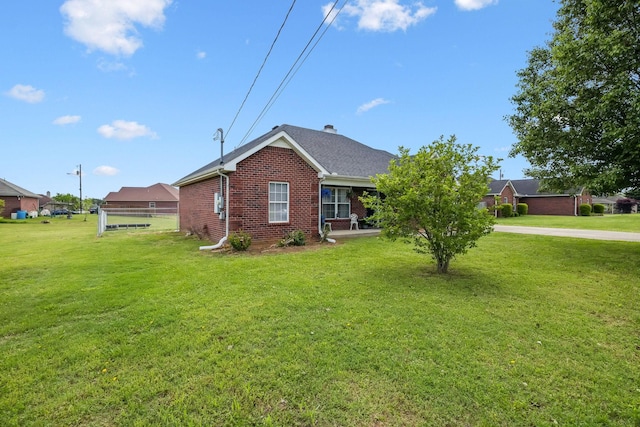view of home's exterior featuring a yard and brick siding