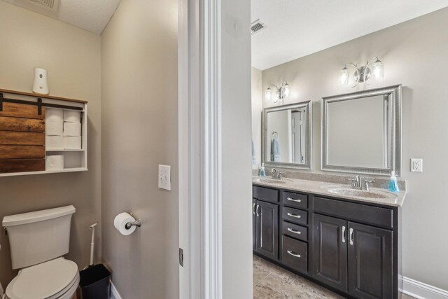 1792 Antler Rd, Woodlawn, TN 37191 - bathroom with double vanity, a sink, tile patterned flooring, and toilet