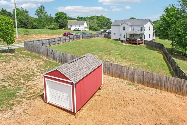 1792 Antler Rd, Woodlawn, TN 37191 - view of yard featuring a fenced backyard, an outbuilding, a deck, and a detached garage