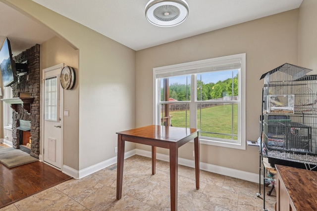 1792 Antler Rd, Woodlawn, TN 37191 - office with baseboards, arched walkways, stone finish floor, and a fireplace