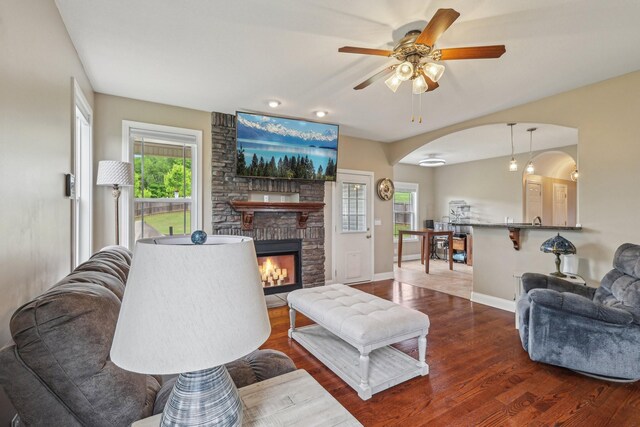 1792 Antler Rd, Woodlawn, TN 37191 - living room with baseboards, arched walkways, a ceiling fan, and wood finished floors