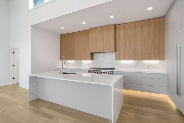 1017 12th Ave S Unit A, Nashville, TN 37203 - kitchen featuring stainless steel gas cooktop, a sink, modern cabinets, and light wood-style floors