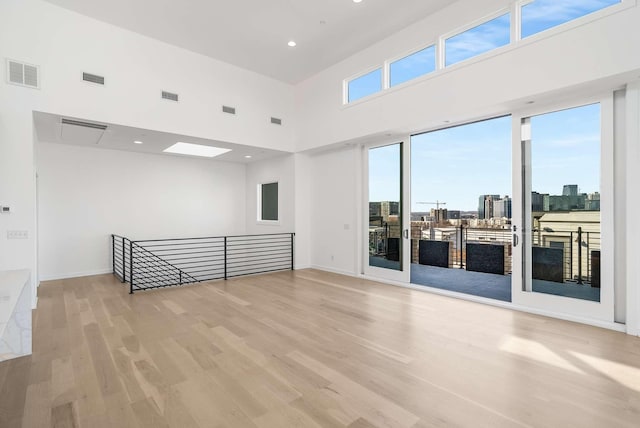 1017 12th Ave S Unit A, Nashville, TN 37203 - spare room with a high ceiling, recessed lighting, wood finished floors, and visible vents
