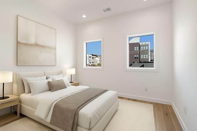 1017 12th Ave S Unit A, Nashville, TN 37203 - bedroom with wood finished floors, multiple windows, and recessed lighting