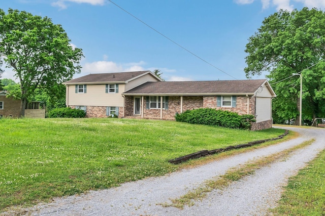 1416 Brannom Dr, Madison, TN 37115 - split level home featuring brick siding, a front lawn, and driveway