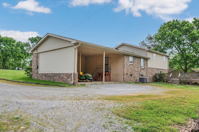 1416 Brannom Dr, Madison, TN 37115 - rear view of property with brick siding, central AC unit, a lawn, and a deck