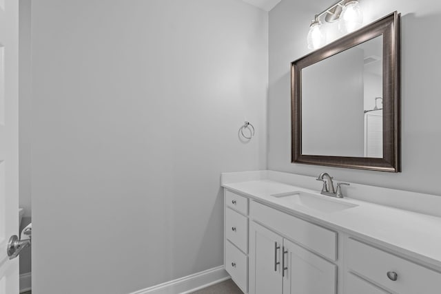bathroom with baseboards and vanity