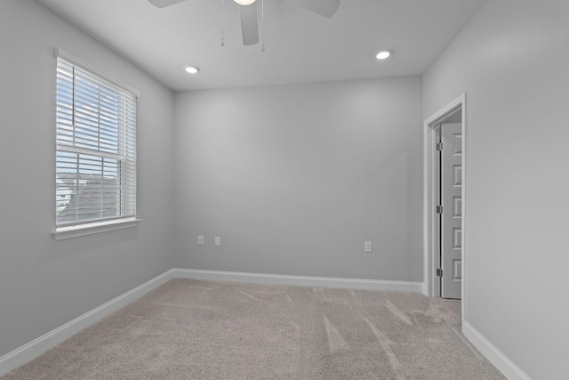 unfurnished room featuring carpet flooring, ceiling fan, and baseboards