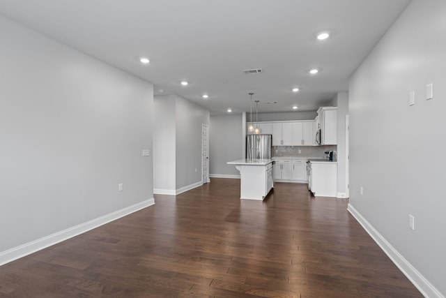 unfurnished living room featuring recessed lighting and baseboards