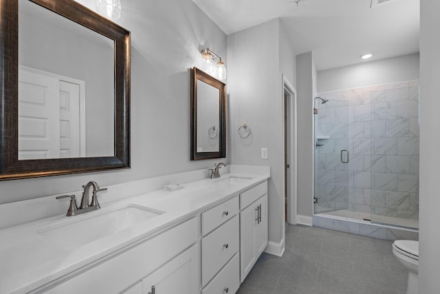 full bathroom featuring tile patterned flooring, a sink, toilet, and a shower stall