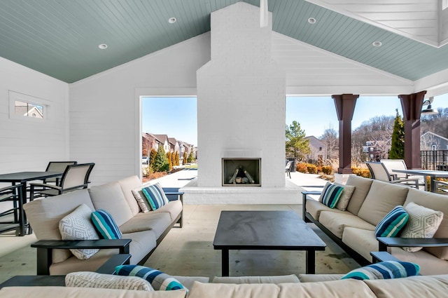 view of patio with outdoor dining area and an outdoor living space with a fireplace