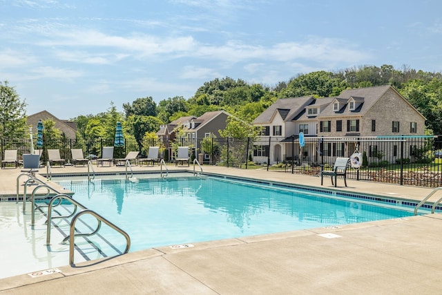 community pool featuring a patio area and fence