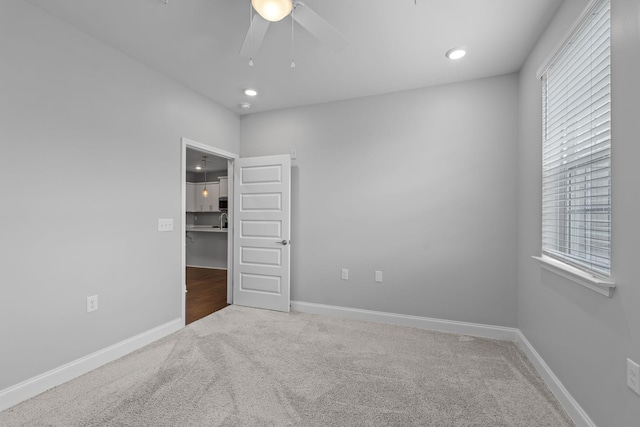 empty room featuring carpet flooring, ceiling fan, and baseboards