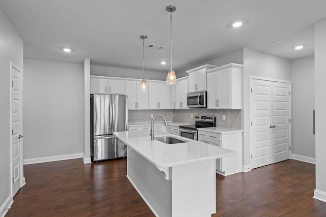 kitchen featuring visible vents, decorative backsplash, light countertops, a sink, and stainless steel appliances