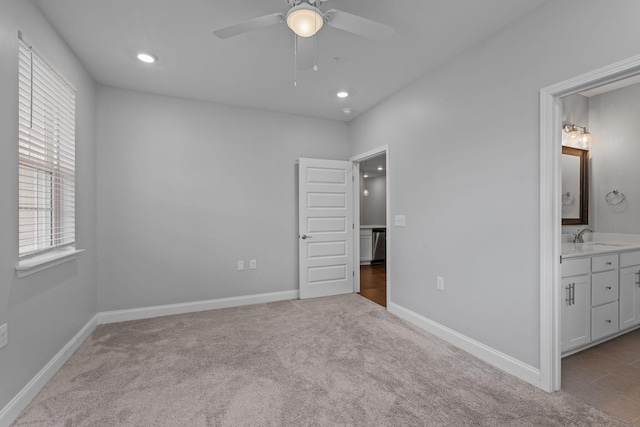 unfurnished bedroom featuring a sink, carpet floors, baseboards, connected bathroom, and recessed lighting