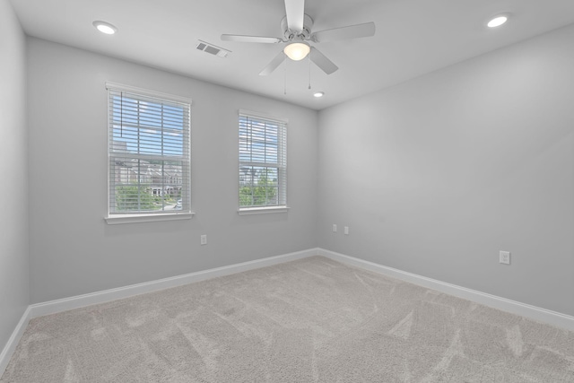 carpeted spare room with baseboards, a ceiling fan, recessed lighting, and visible vents