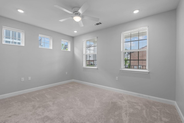 carpeted spare room featuring visible vents, recessed lighting, baseboards, and ceiling fan