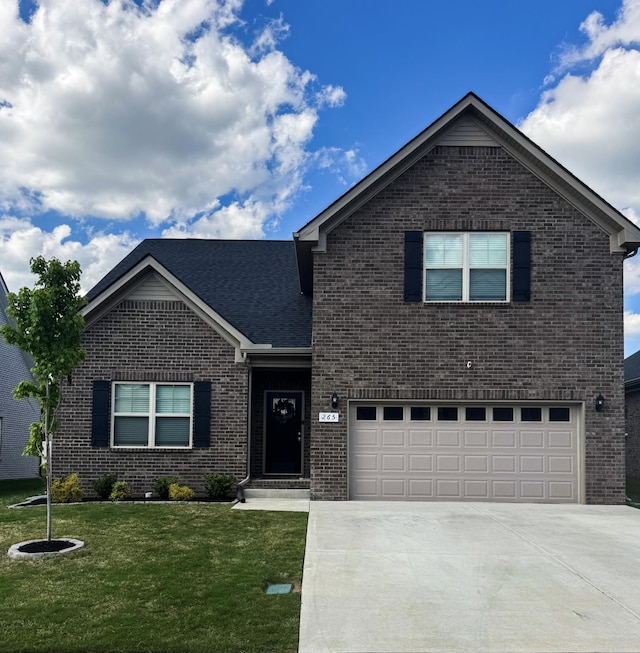 traditional-style home with a garage, concrete driveway, a front yard, and brick siding