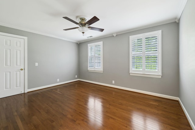 empty room featuring crown molding, visible vents, hardwood / wood-style floors, baseboards, and ceiling fan