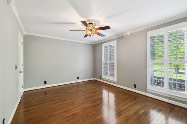 spare room with wood-type flooring, a ceiling fan, baseboards, and ornamental molding