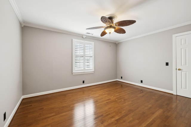 empty room with visible vents, ornamental molding, wood finished floors, baseboards, and a ceiling fan