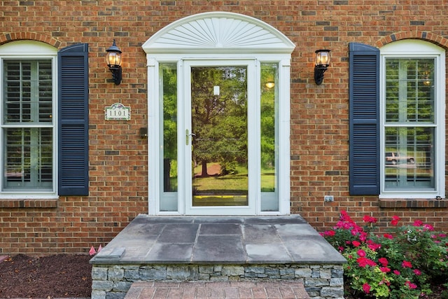 property entrance with brick siding